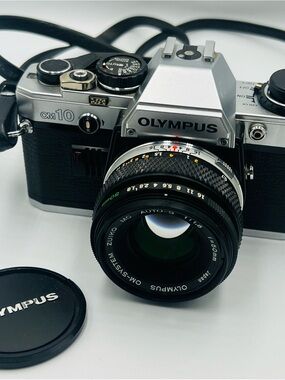 Olympus 35mm SLR Camera in Silver and Black with Zuiko Lens
